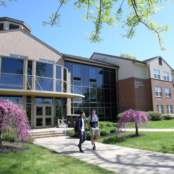 Students walk on path near residence hall