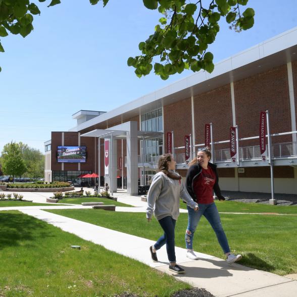 Students walk in front of Bart Luedeke Center