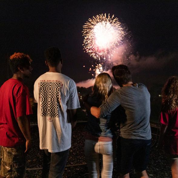Group of students watch fireworks together.