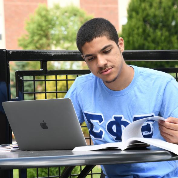 Student sits outside to study