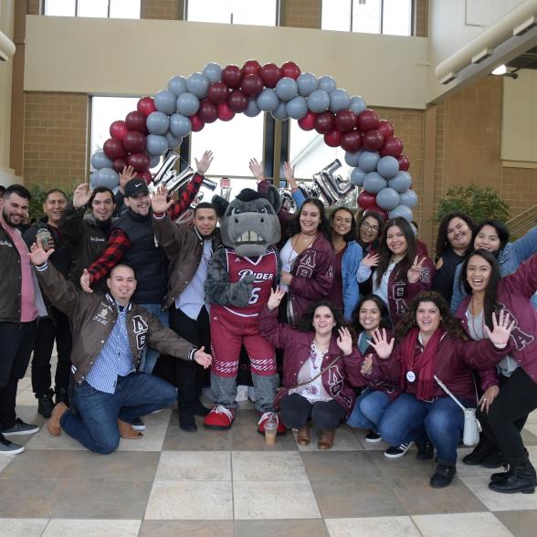 Lambda Theta Alpha Latin sorority and Lambda Theta Phi Latin fraternity members with A.J. the Bronc