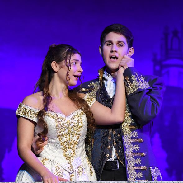 A male and female student sing together during an opera performance of Cendrillion