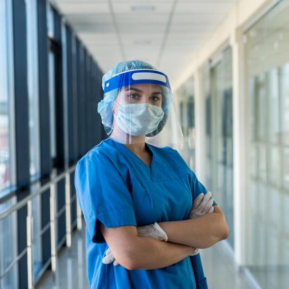 Nurse wears face shield and scrubs