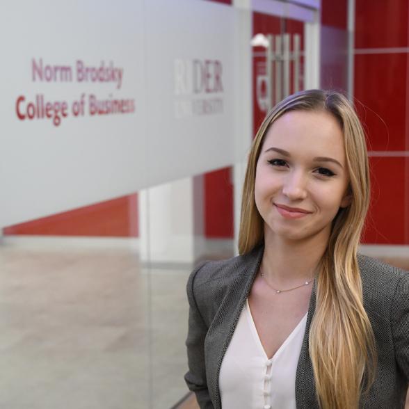 Student stands in Norm Brodsky College of Business hallway