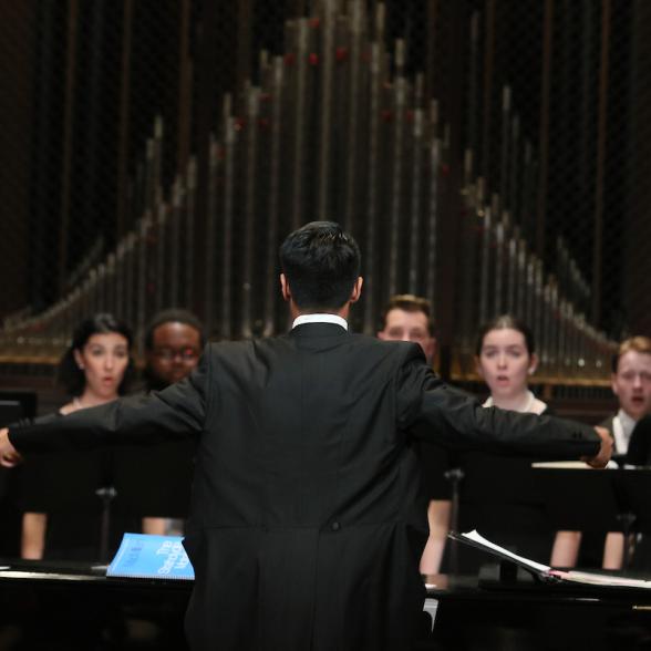Male student conducting Westminster Choir