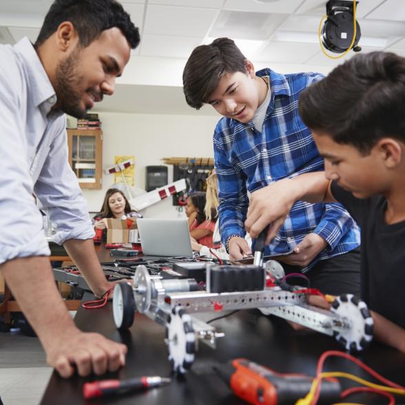 Teacher builds robot with students.