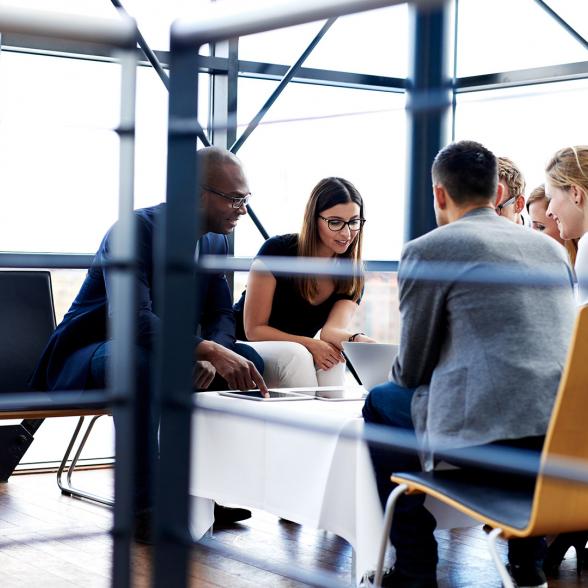 Group of business students at a table studying.