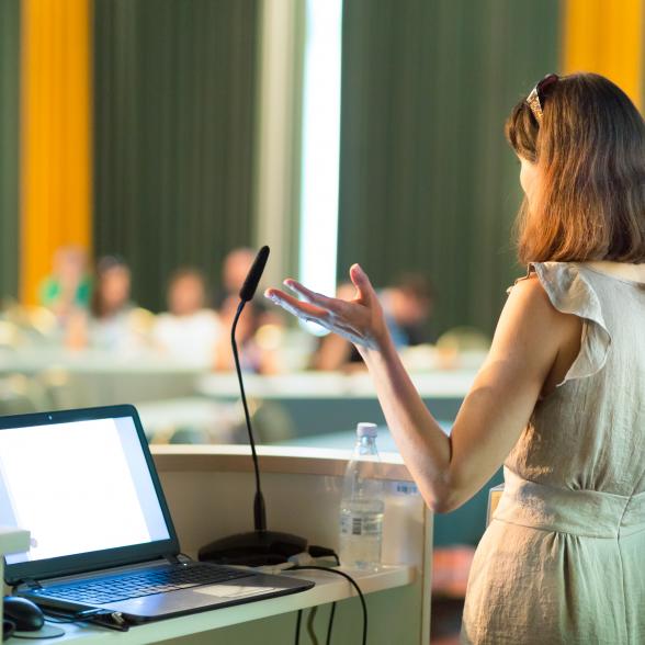 Woman presents at a conference