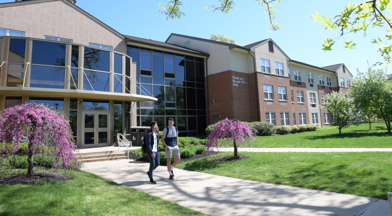Students walk on path near residence hall