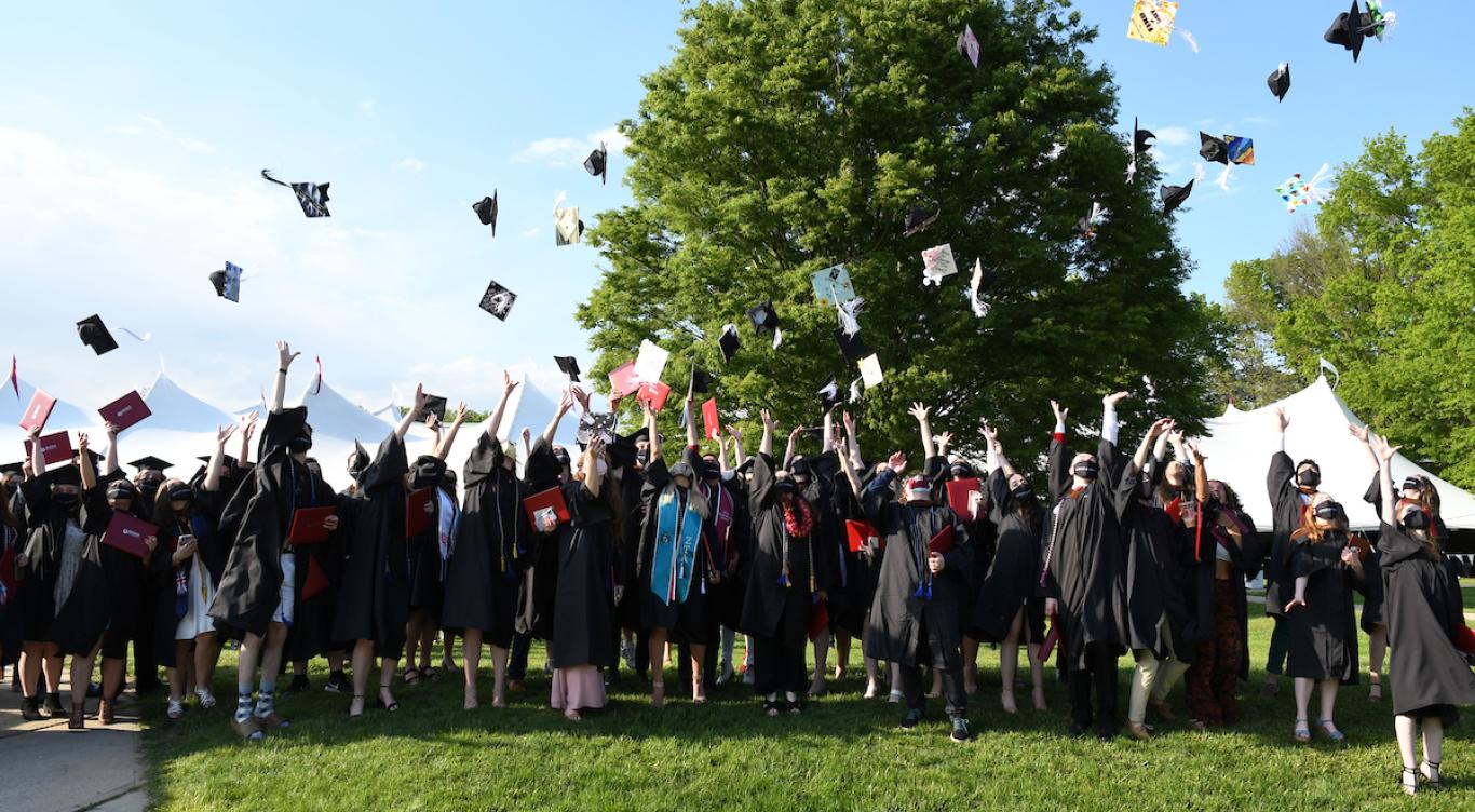 2021 graduates toss their caps