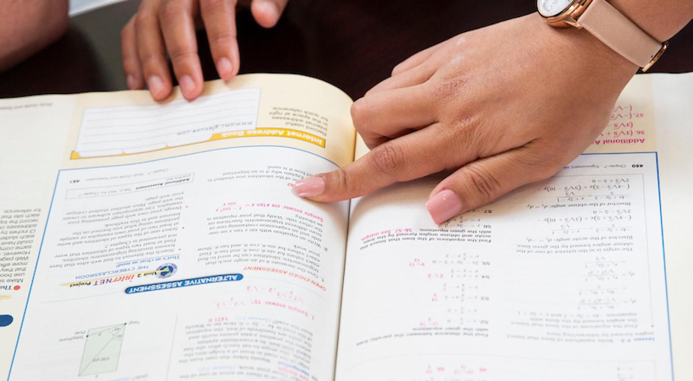 Students reading a textbook