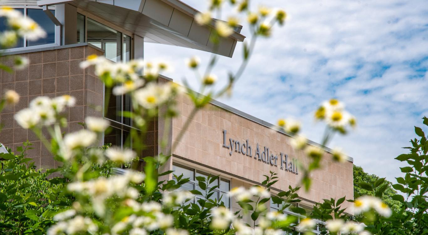 Lynch Adler Hall with flowers.