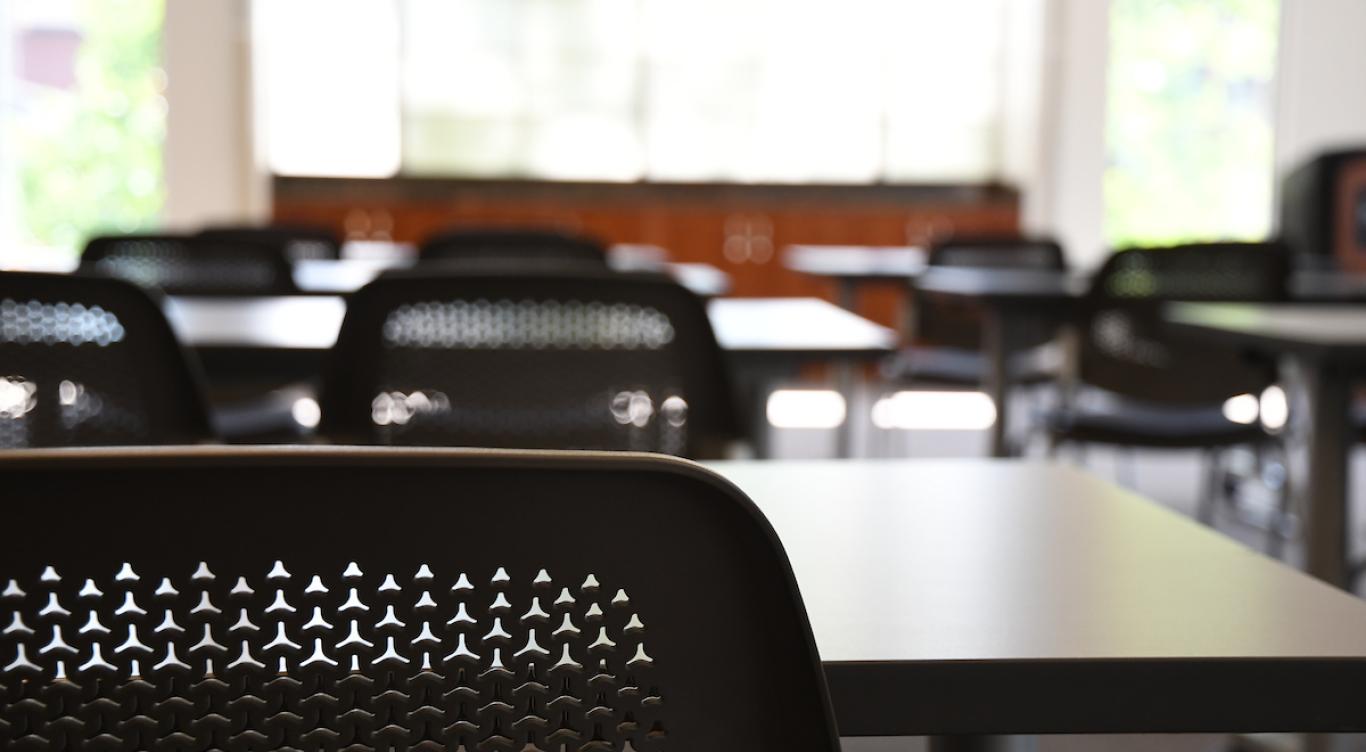 Desks and tables in a classroom. 