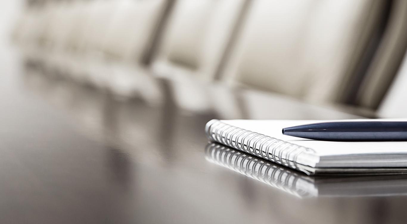 image of a notepad on a conference room table