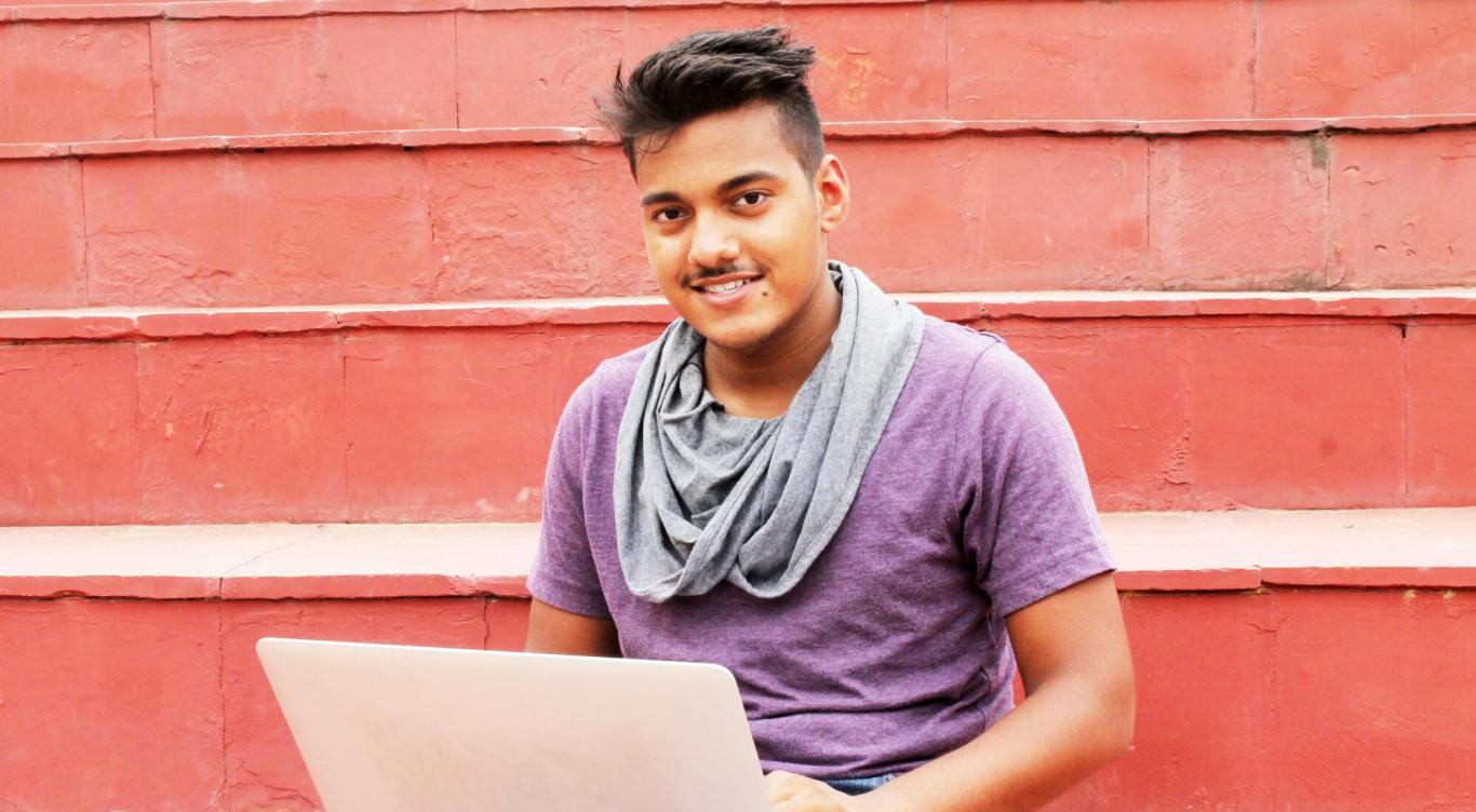 Young man sitting with his laptop