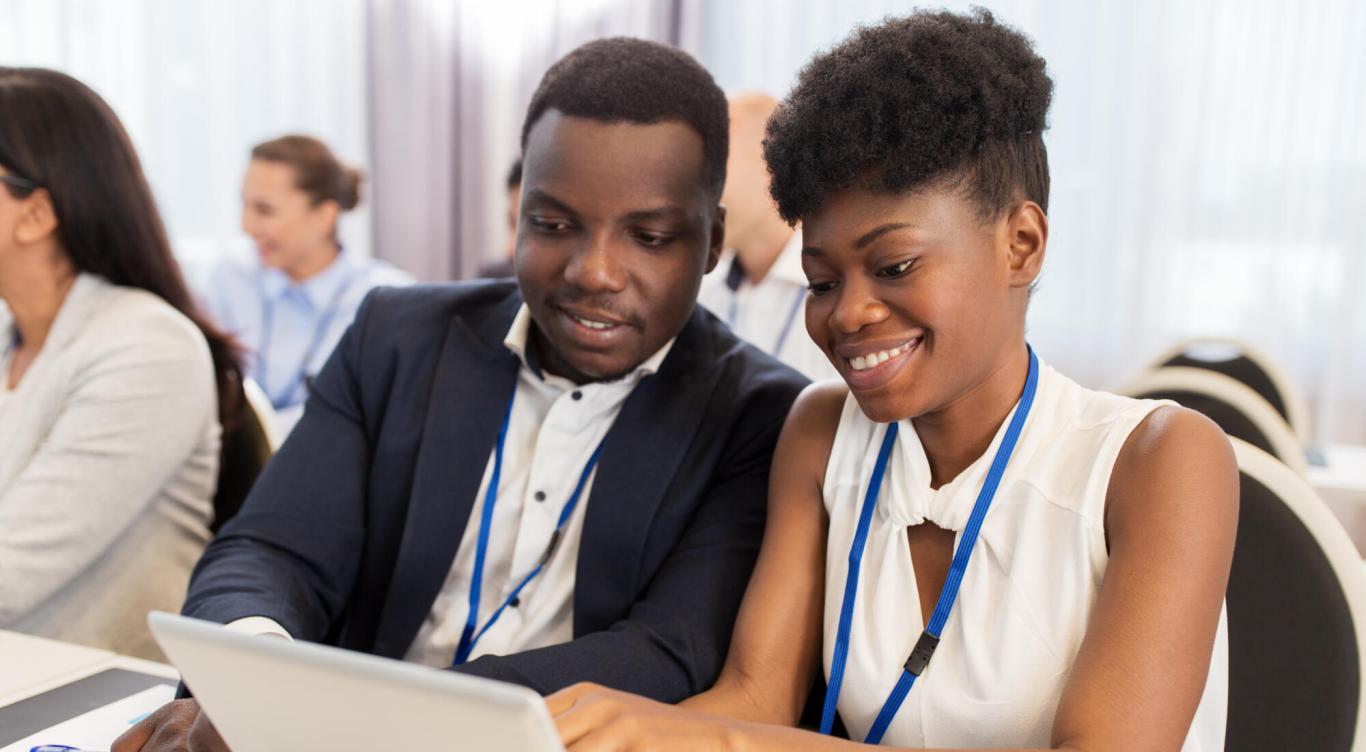 Two colleagues look at presentation