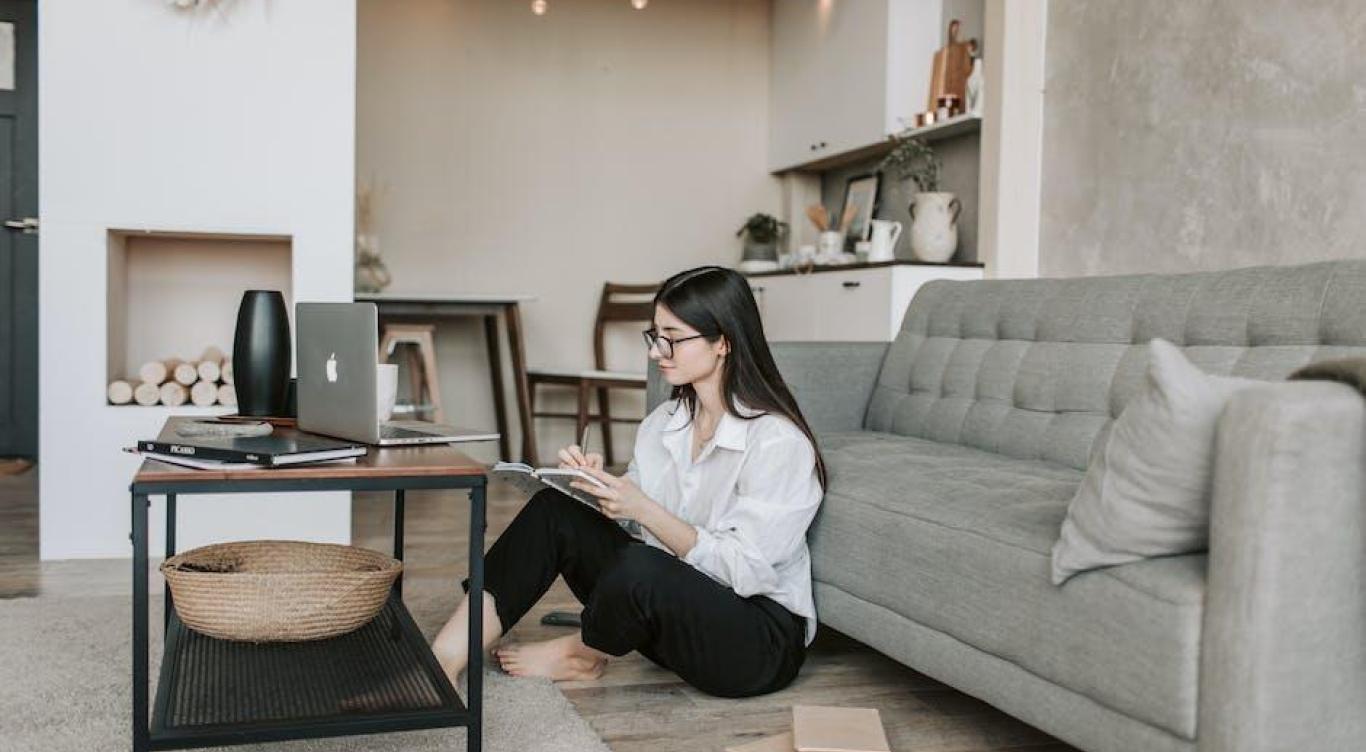Woman sitting on floor looking at computer