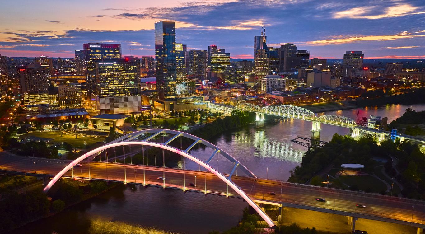 Aerial View of Illuminated Nashville Skyline and Bridge at Twilight stock photo