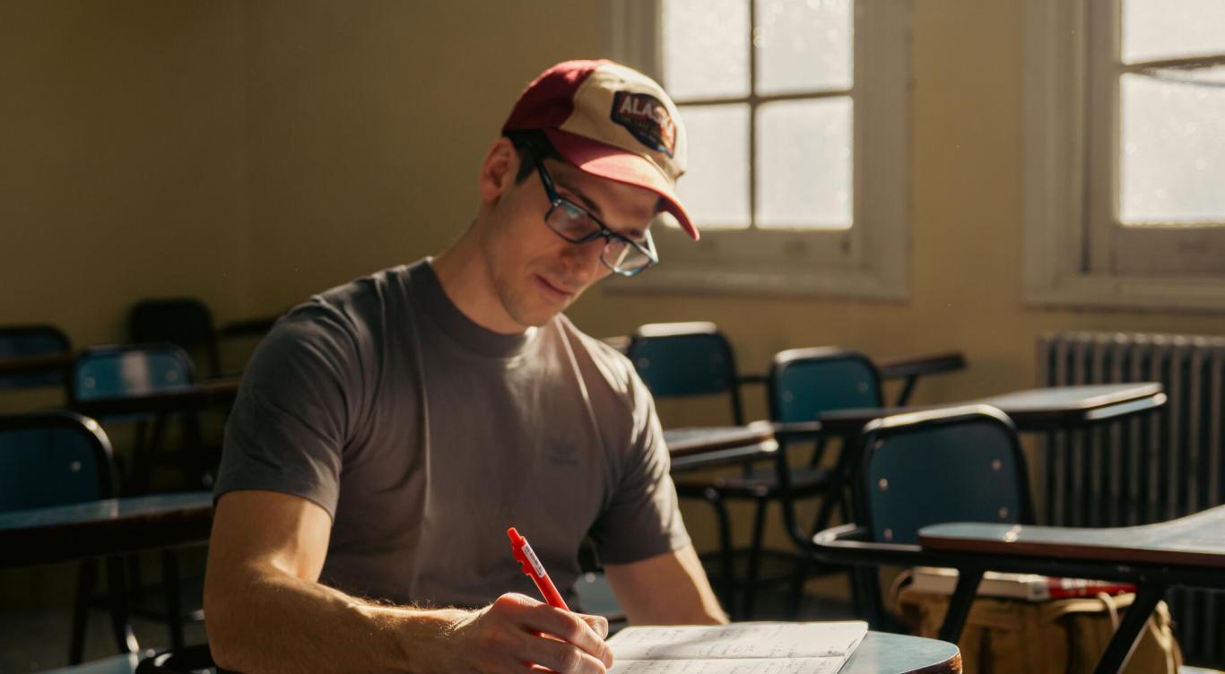 Veteran sitting at desk writing