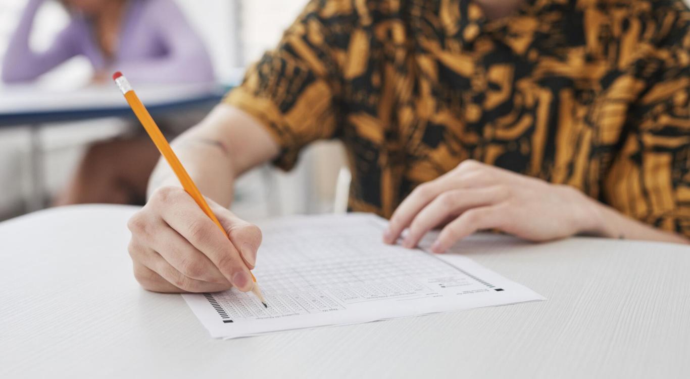 Person writing on a test