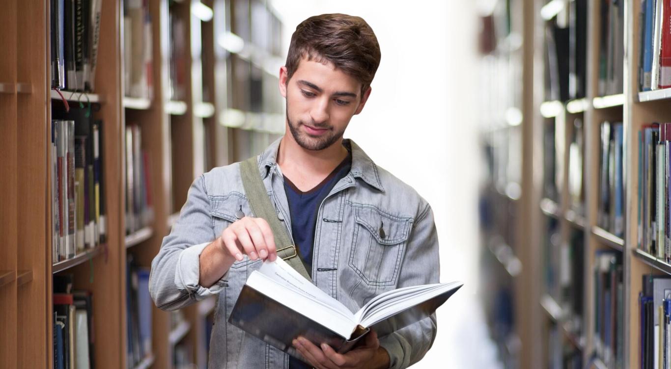 Young man looking at book