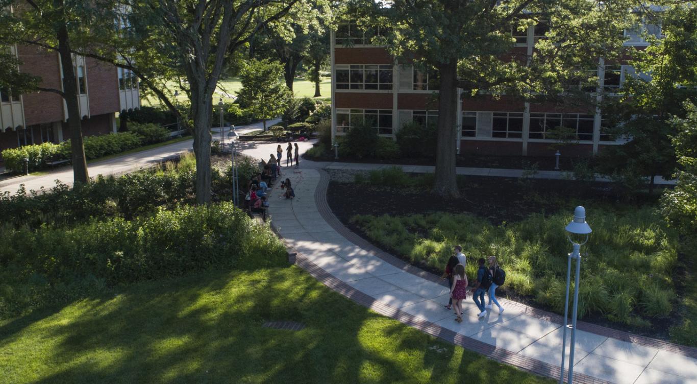 Groups of students walk outside on Rider campus.