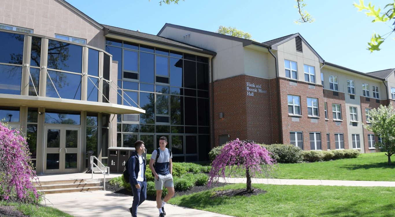 Students walk outside of Rider dorms.