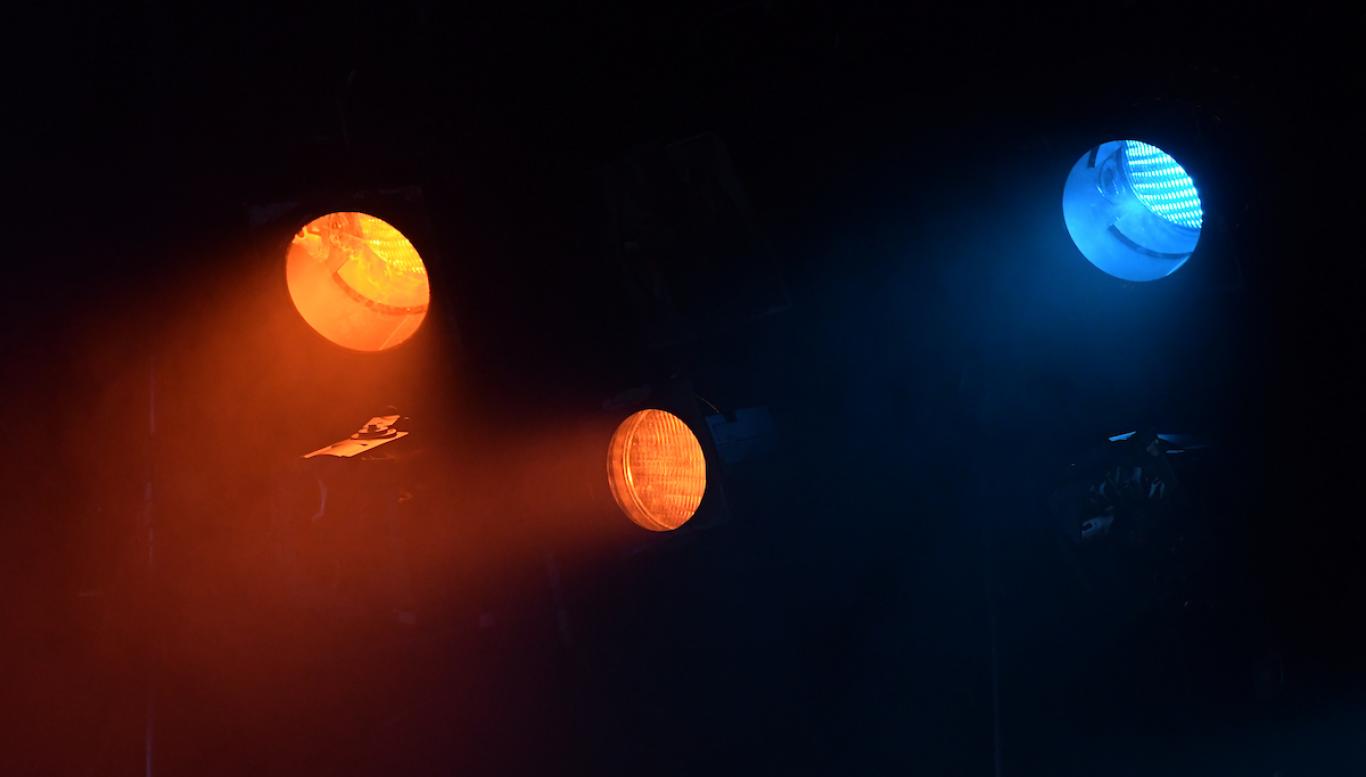 Three spotlights on stage