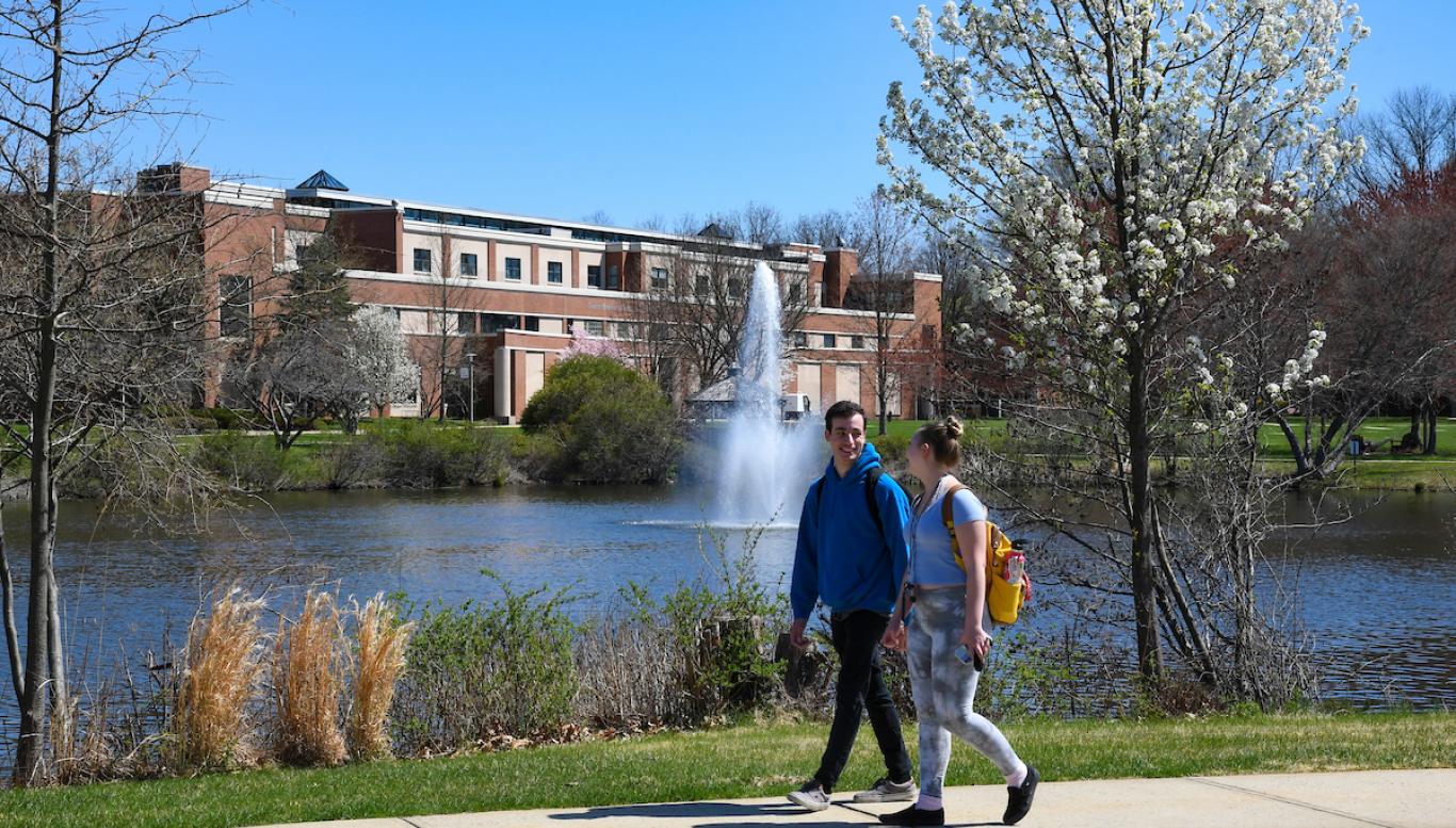 Students walk near Centennial Lake