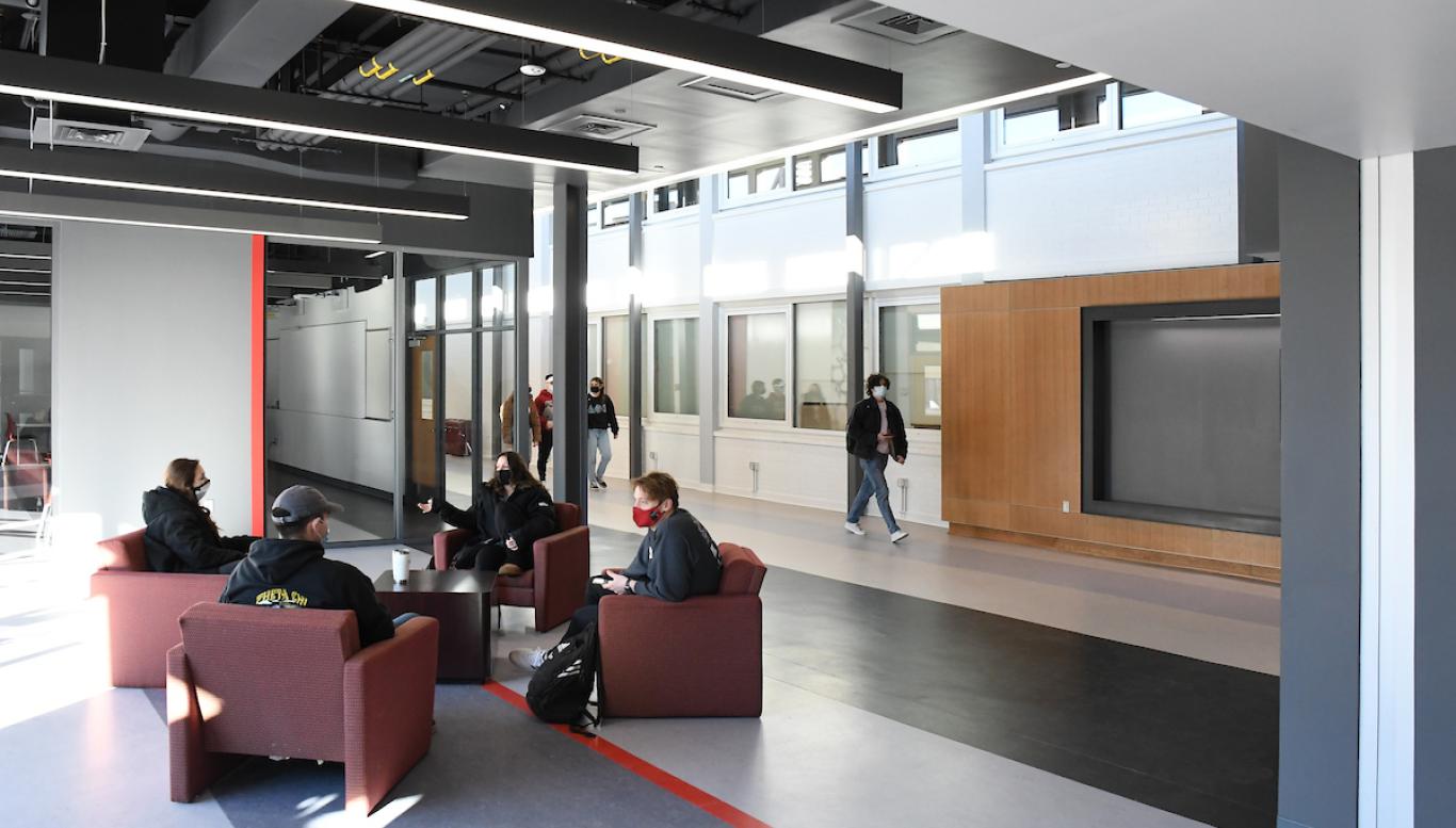 Students converse in the Science and Technology entryway