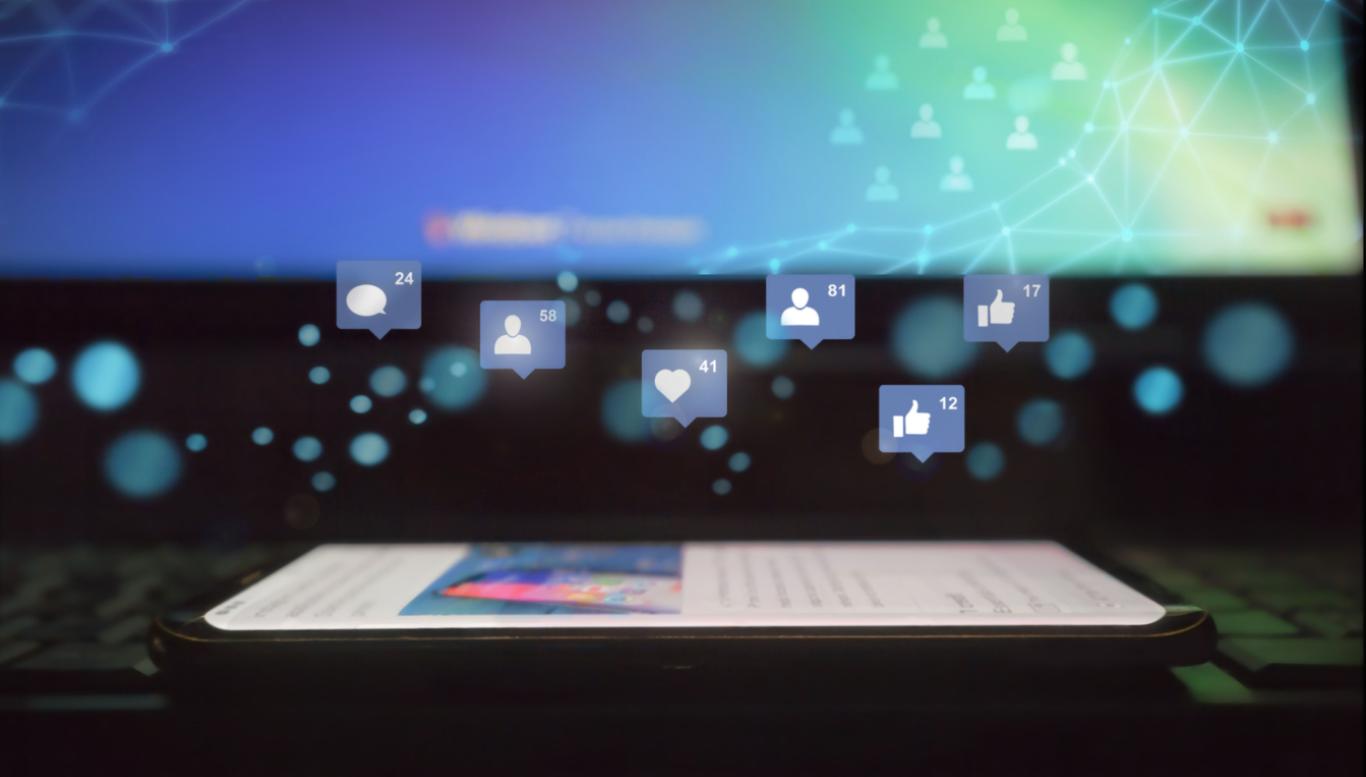 Social media icons hover above tablet