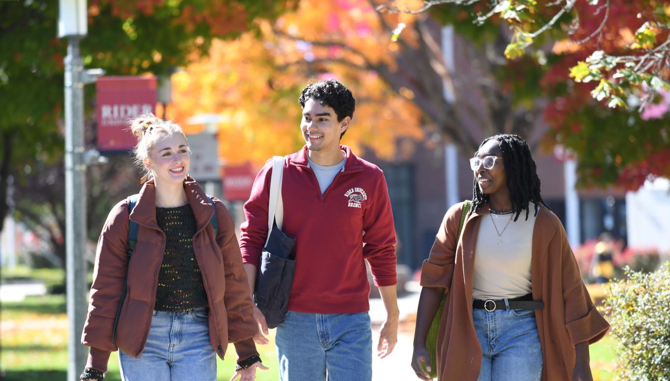 Students walking campus in the fall