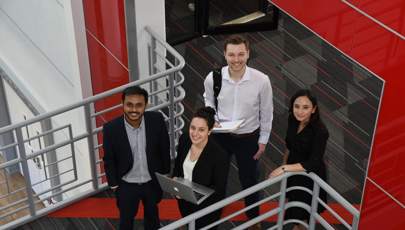 Four students on a staircase