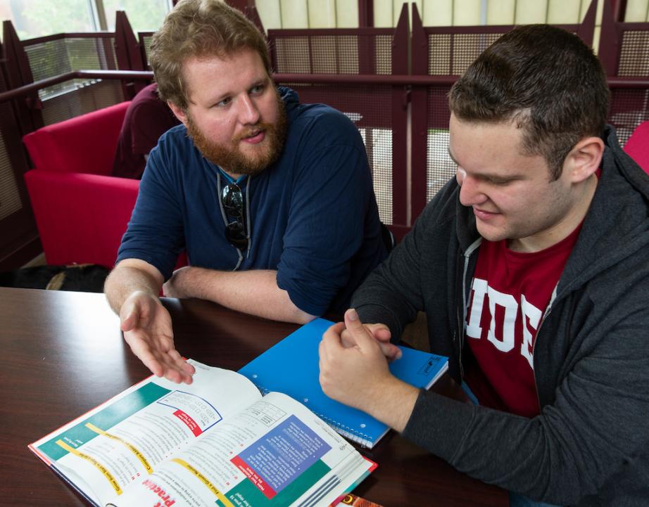 Two students looking at a textbook.