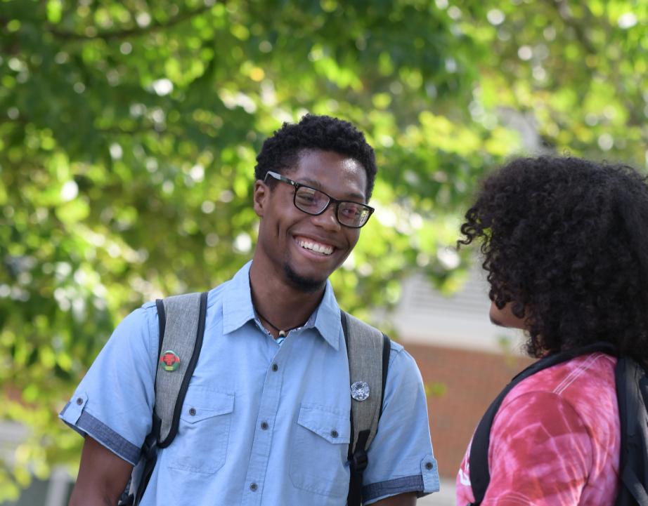 Two students talk with each other
