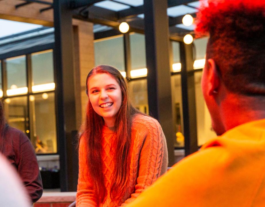Students talk near fire pit