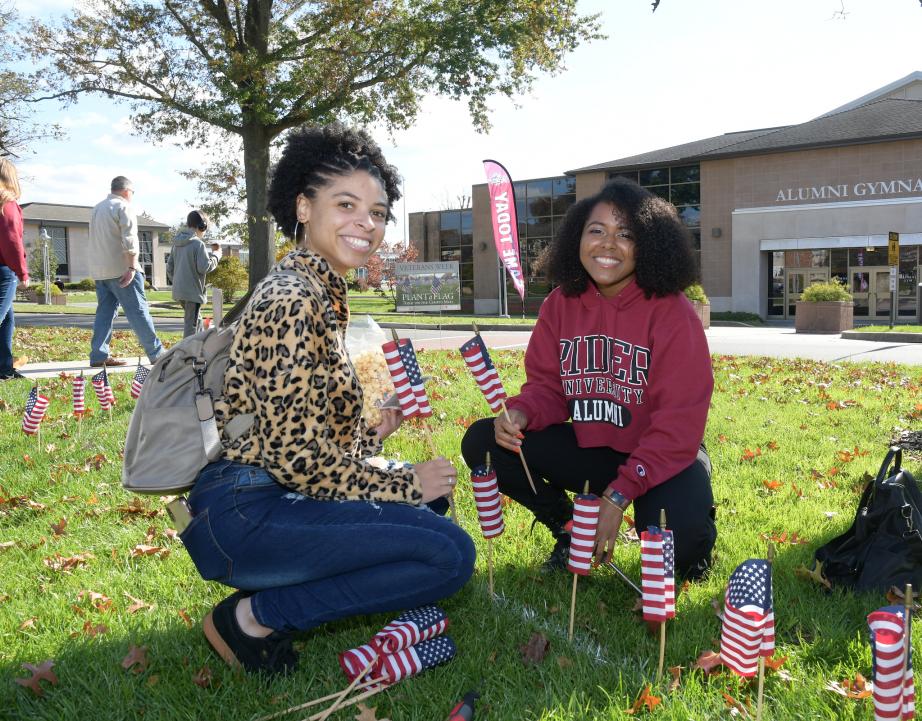 Alumni plant flags during Family Weekend