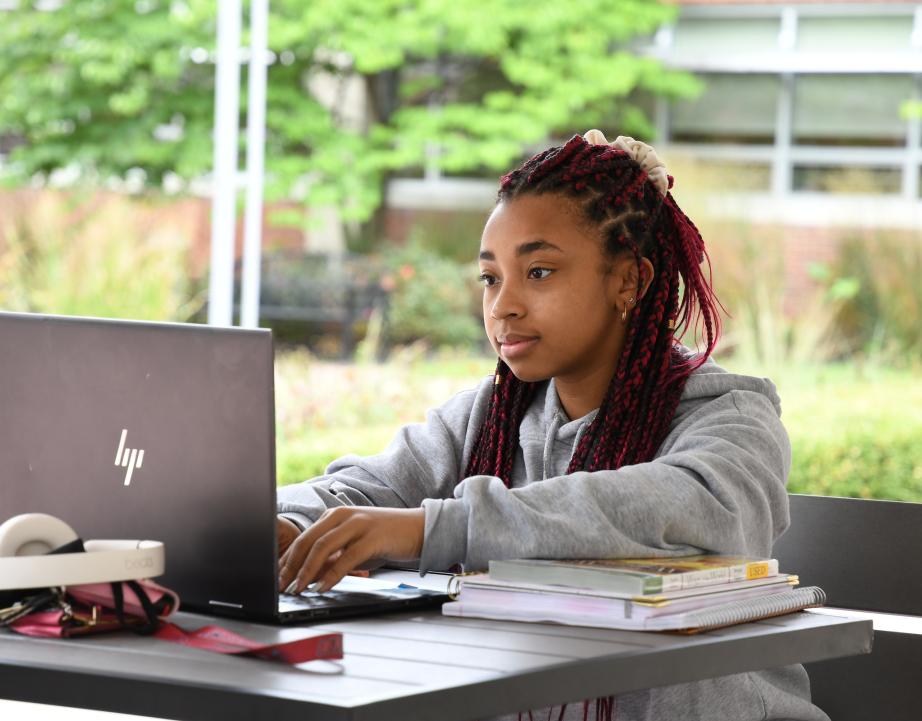 Student working outside on laptop 