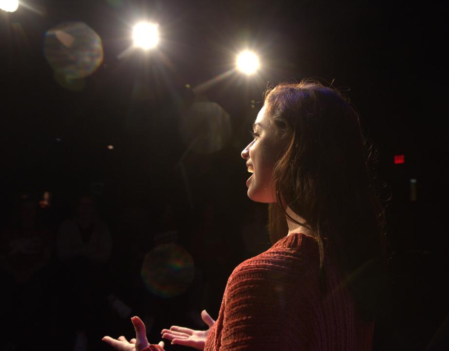 Student singing on stage