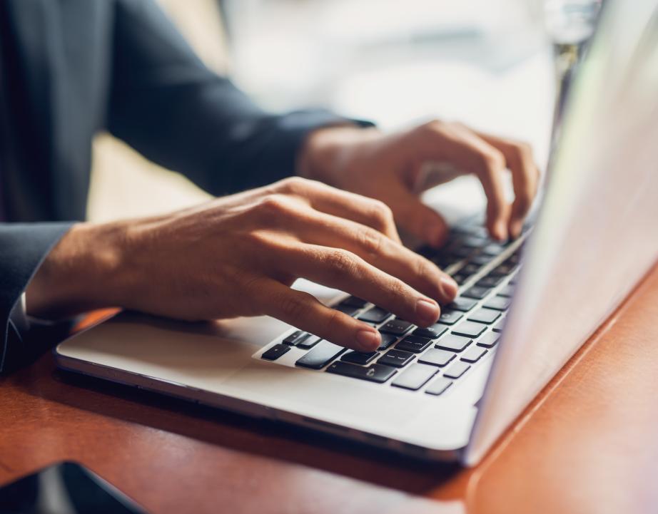 Person types on laptop computer