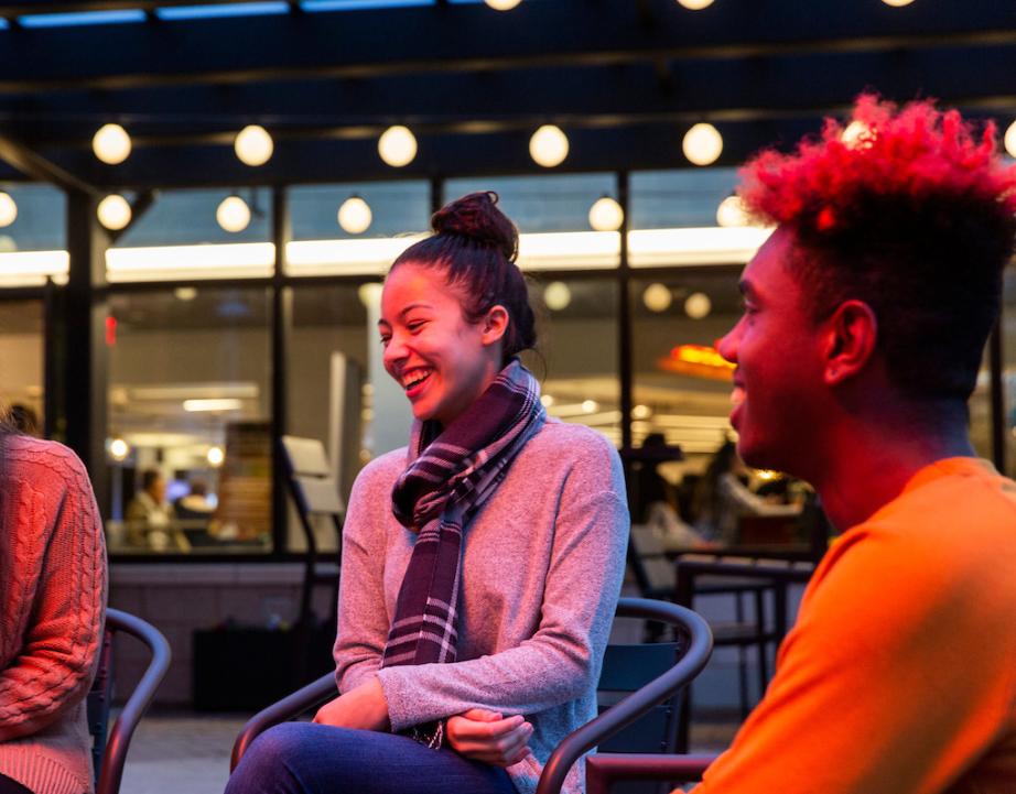 Students laugh together on BLC patio