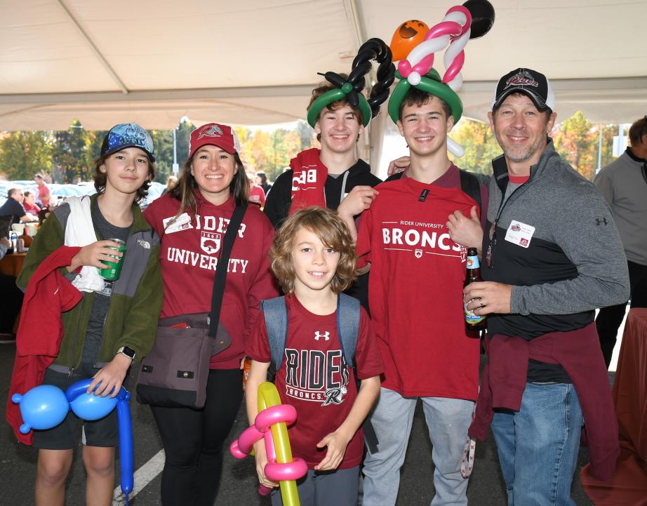 Family poses for photo at alumni event