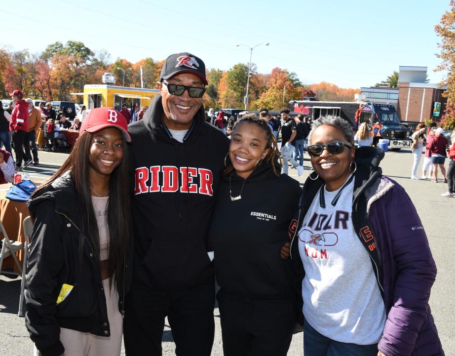 Family pose for photo at Homecoming weekend