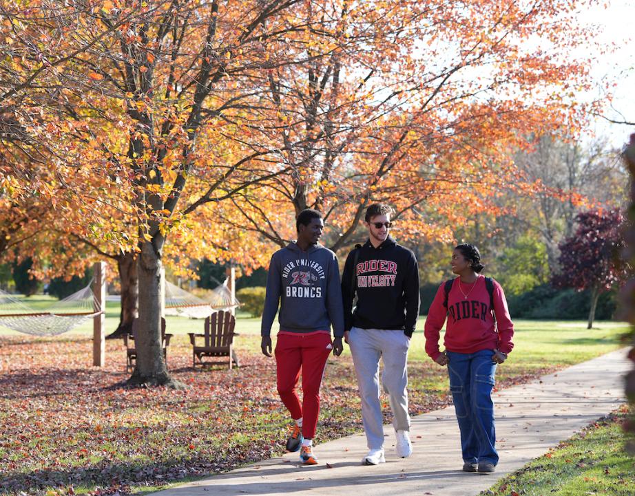 Three students walk on campus