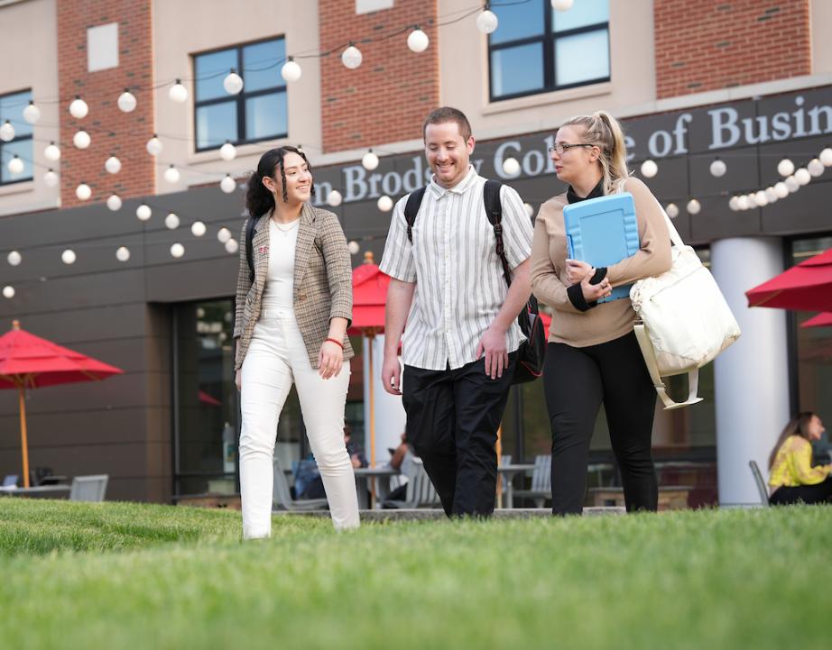 Graduate students talk as they leave Sweigart Hall