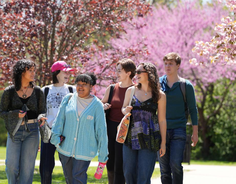 group of students walking on campus in the spring