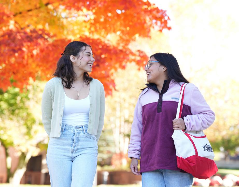 two students walking on campus in the fall