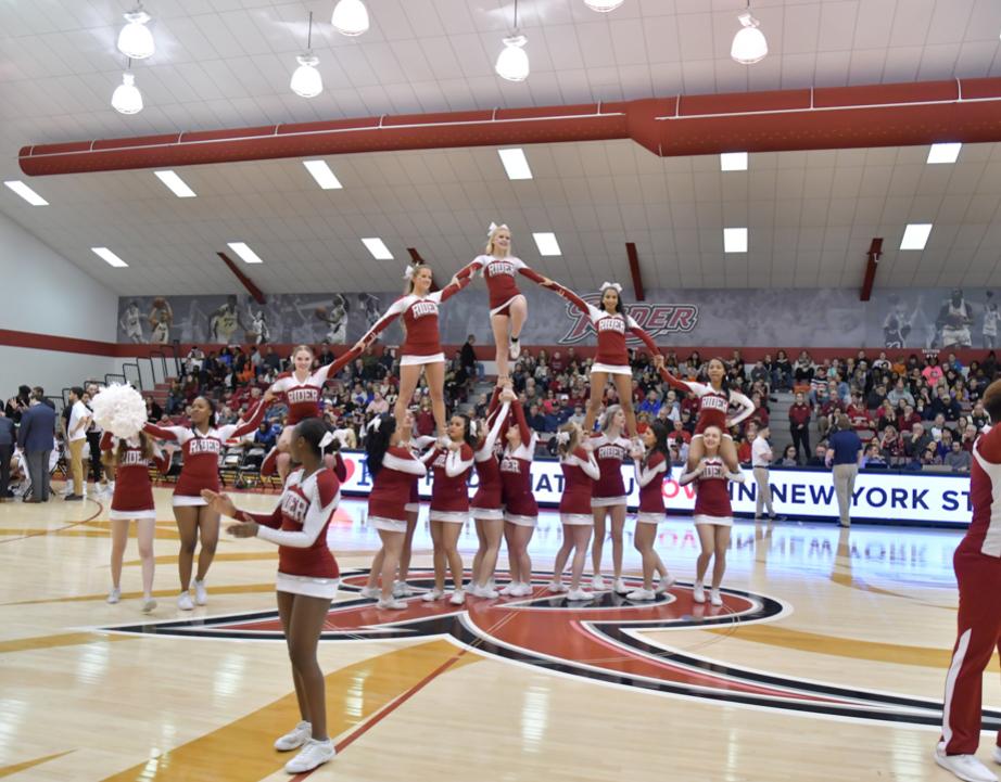 Cheerleaders cheer at basketball game.