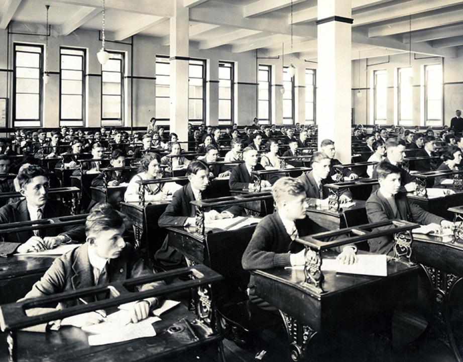 Male_and_female_students_seated_at_desks_in_classroom.jpg