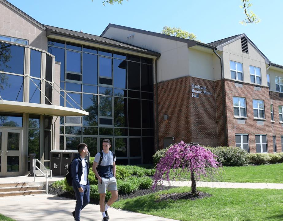 Students walk outside of Rider dorms.